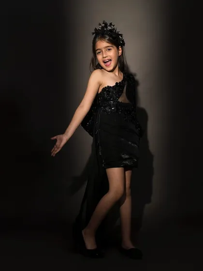 This one shoulder black dress is for the little fashionista who loves a bit of drama. With sequin embroidery and a flowing side tail, it’s a chic and stylish choice for cocktail parties or milestone birthdays.