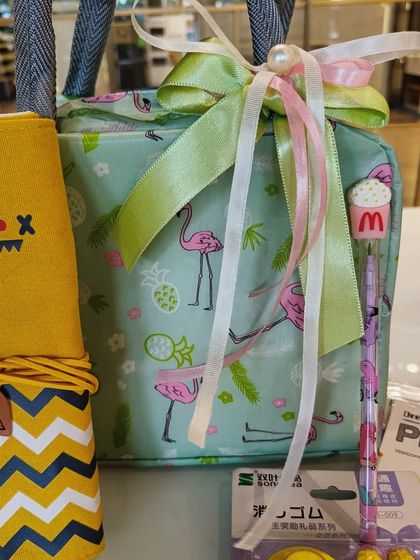 A fun and practical gift for kids, this set includes a flamingo-themed lunch bag and a cute monster pencil case.