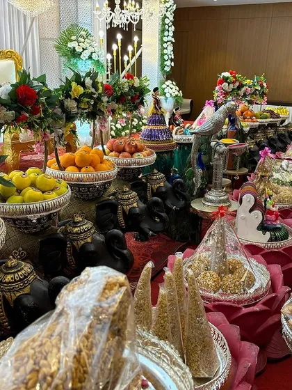 A variety of offerings displayed on black elephant props and in silver bowls.