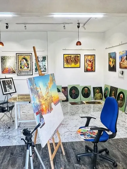 Another view of the studio, with an easel and painting in progress at the center. The space is organized to inspire creativity, with good lighting and my work surrounding me.