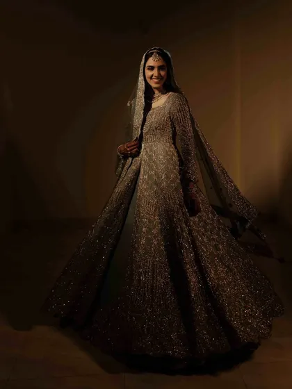 A joyful, twirling portrait of the bride in her magnificent gown. The motion and her bright smile convey a sense of celebration and freedom.