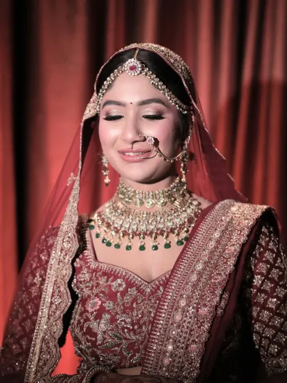 A moment of quiet reflection for the bride. Her makeup, with soft, shimmery eyes and a flawless base, looks beautiful and serene.