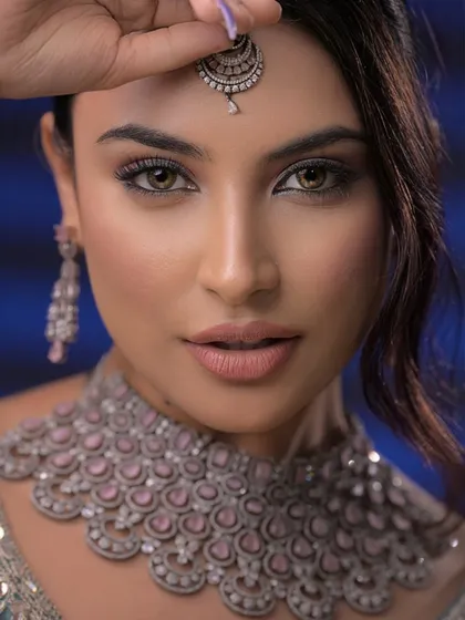 This pose draws attention to the maang tikka, showing how makeup can be used to frame and enhance accessories.
