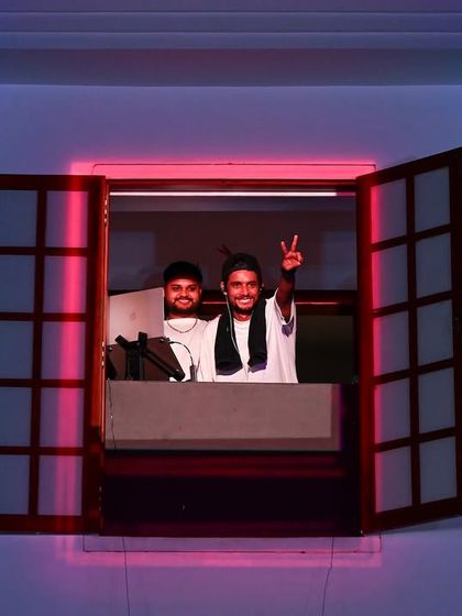 A unique DJ booth setup, spinning from a window overlooking the massive crowd at the Red Bull Delhi Regional. We always find new ways to bring the music to the people.