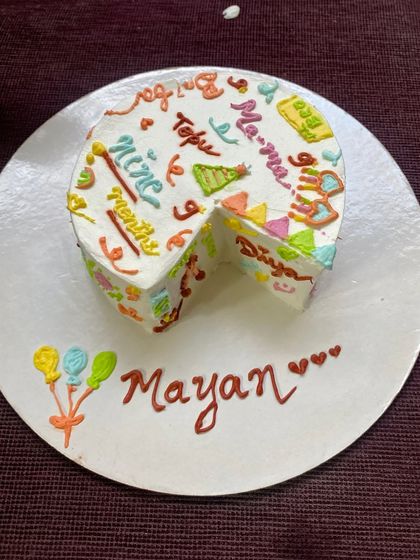 The full doodle cake, with a slice taken out to show the delicious chocolate truffle layers inside.