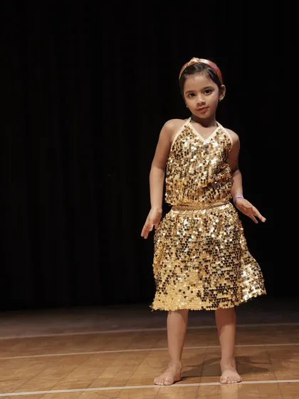 This young dancer from our 'Little Champs' troupe strikes a perfect pose. Our choreography for this age group focuses on simple, memorable, and impactful moves.