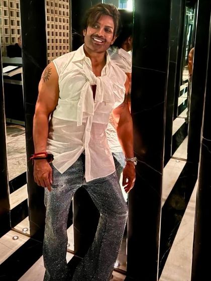 A full-length view of the sparkling bling jeans, paired with a custom sleeveless shirt for a truly unique and glamorous party outfit.