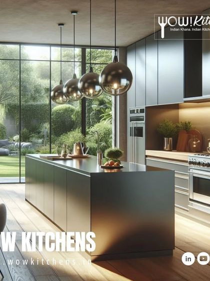 A minimalist approach to luxury. This kitchen features a massive, dark monolithic island, sleek handleless cabinets, and a full wall of glass that opens up to a lush garden, blending indoor and outdoor living.