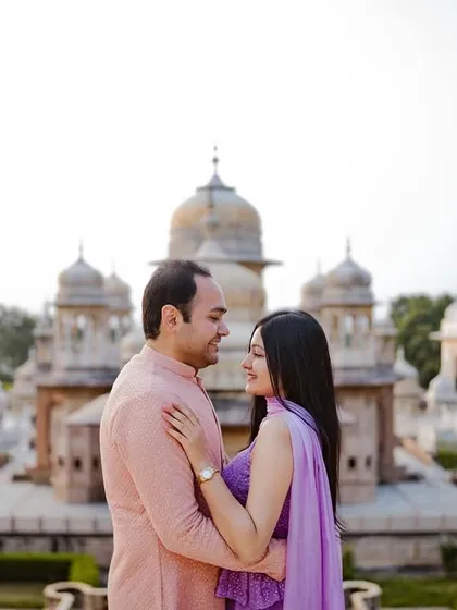 Raghav and Tanisha's pre-wedding shoot at a heritage location in Udaipur. The stunning white cenotaphs provide a serene and royal backdrop, perfectly complementing their elegant traditional attire.