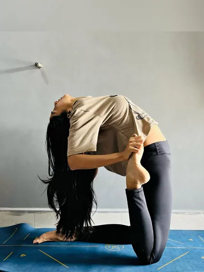 Perfect practice makes progress. This is an advanced variation of Camel Pose, showing how consistent practice can lead to deeper flexibility and back-bending capabilities.