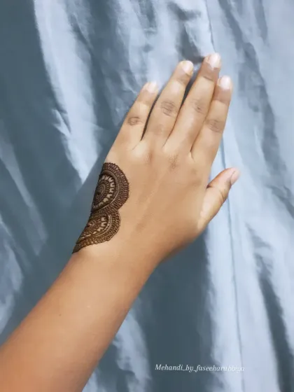 The start of a bold henna tutorial, showing the first section of a large, graphic design.