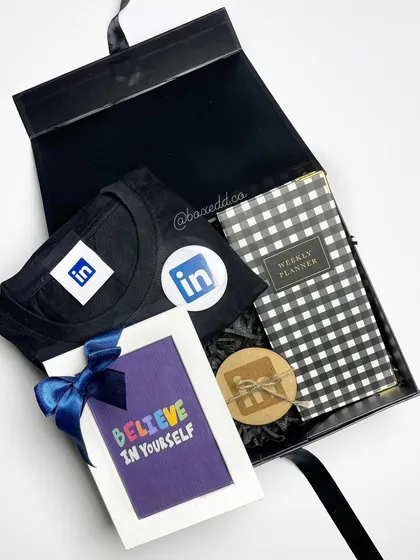 This welcome kit for LinkedIn is designed to inspire. It includes a branded t-shirt, a weekly planner, and a motivational card, showing that onboarding gifts can be both practical and uplifting.