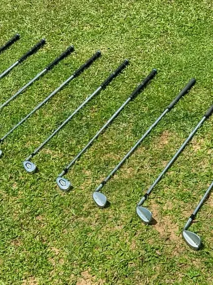 Here is a full set of irons laid out on the green. During a fitting, we analyze every club in your bag, from the long irons to the wedges, to ensure each one is optimized for your swing.