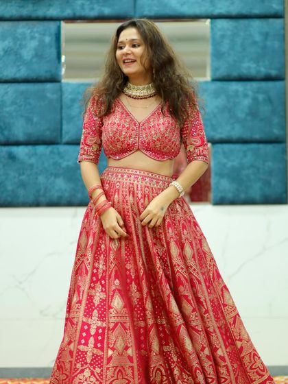 This happy customer is twirling in one of my favorite Banarasi lehengas. The rich red fabric and traditional gold patterns make it a timeless choice for a bride.
