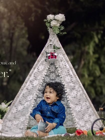 Cute, curious, and full of cheer. This happy boy enjoys his first birthday cake in our outdoor teepee setup.