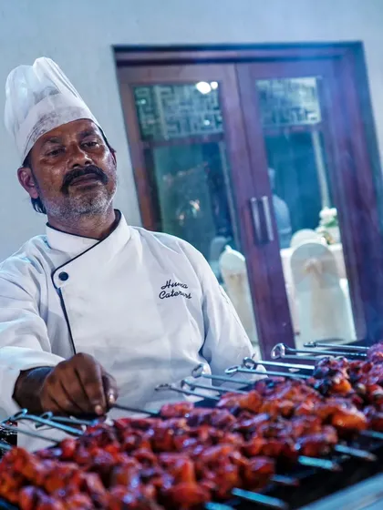 Our experienced chef managing the grill, ensuring every piece of chicken tikka is cooked to perfection with a beautiful char.
