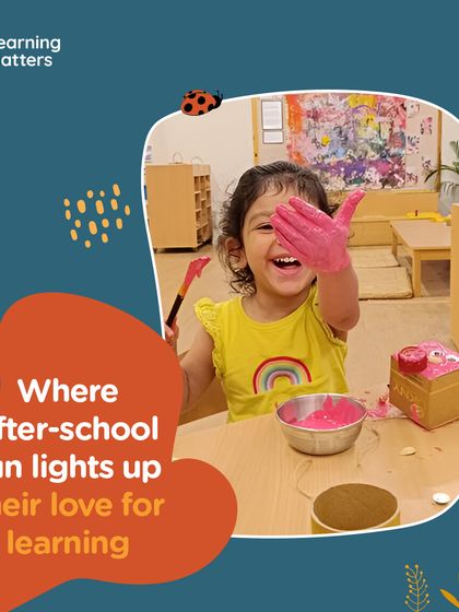 The pure joy on this child's face says it all. With a hand full of pink paint, she is not just making a mark, she is expressing herself. We celebrate these moments of uninhibited, joyful creation.