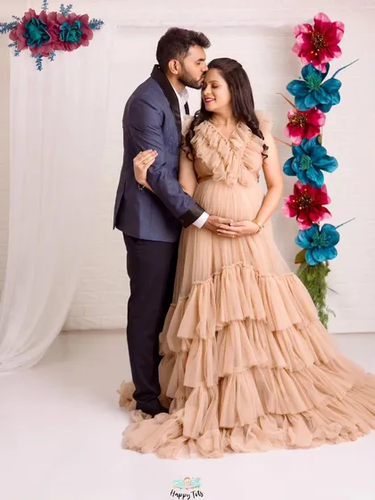 A beautiful, formal couple portrait. The dad-to-be's gentle kiss on her forehead is a timeless expression of love and protection.