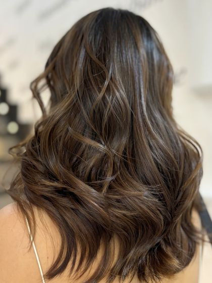 The elegance of a Froid Brunette balayage. This cool-toned brown is beautifully crafted by our Style Director for a chic and modern look.