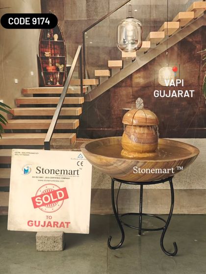 Another view of the tabletop fountain on its stand, showing how it can complement modern interior design.