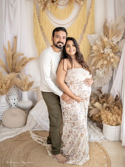 A classic couple pose in our rustic, boho-themed studio. Their embrace is full of warmth and affection, perfectly documenting their journey to parenthood.