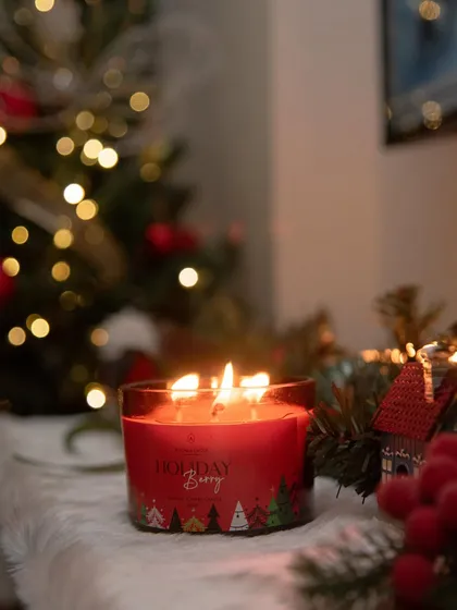 Our 'Holiday Berry' candle burns brightly, its red jar a festive pop of color. This three-wick soy candle is perfect for creating a warm and inviting atmosphere during the New Year celebrations.
