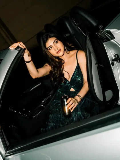 Using a convertible car as a prop, this shot feels glamorous and aspirational, perfect for influencer content.
