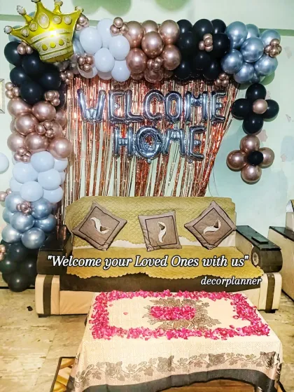 Another look at this loving welcome home setup. The combination of the balloon arch and the rose petal arrangement on the table makes the living room feel instantly celebratory.