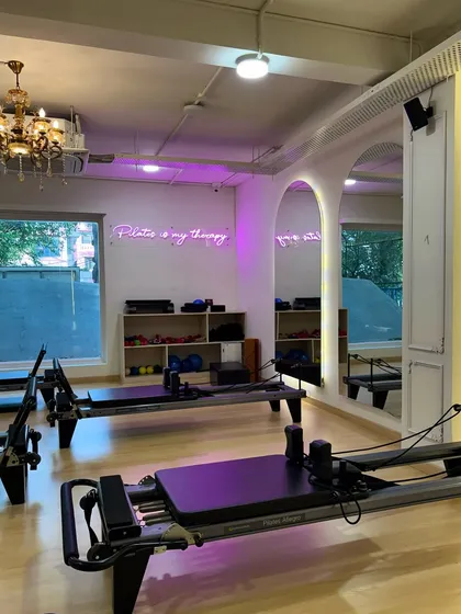 POV: You just walked in to start your hot girl summer era. The reformers are lined up under the glow of my "Pilates is my therapy" sign.