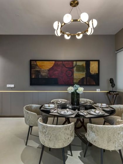 In this luxury apartment, I used a sophisticated grey palette as a canvas for playful and artistic elements. The clean lines and minimalist furniture are punctuated by carefully selected art and a modern chandelier, creating a space that is both calm and full of character.