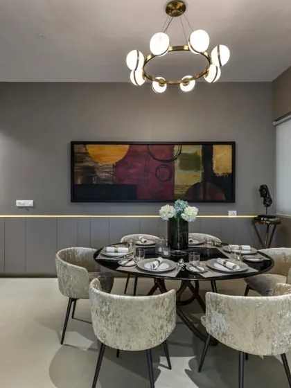 In this luxury apartment, I used a sophisticated grey palette as a canvas for playful and artistic elements. The clean lines and minimalist furniture are punctuated by carefully selected art and a modern chandelier, creating a space that is both calm and full of character.