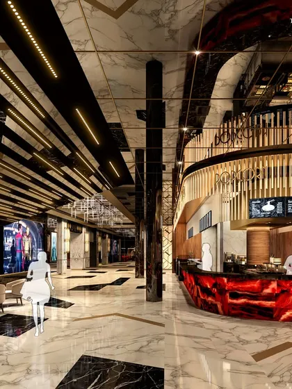 The luxurious lobby and concession area of a high-end cinema. A glowing red onyx bar serves as a dramatic focal point, while elegant furnishings and marble accents provide a warm and inviting atmosphere for a pre-movie treat.