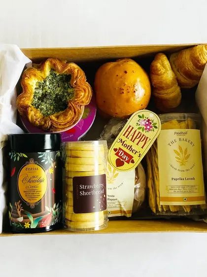 A look inside the Mother's Day bakery box, filled with strawberry shortbread, pastries, and hot chocolate mix.