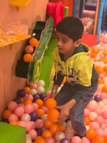 Having a blast in the giant ball pit. This area includes interactive elements like this ball conveyor, adding an extra layer of fun to the experience.