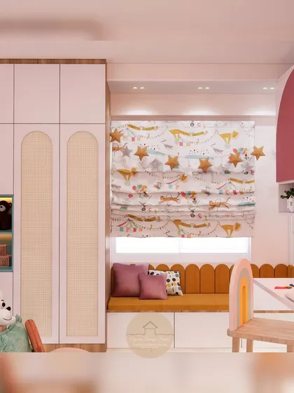 A view of the wardrobe and window seat in the kids' room. The wardrobe has arched cane-paneled doors, and the window seat provides a sunny spot for reading, with extra storage underneath.