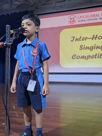 A student from the blue house confidently sings his piece during the competition.