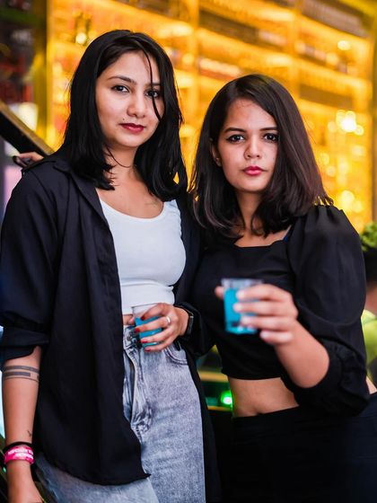 Two friends enjoying some shots at the bar.