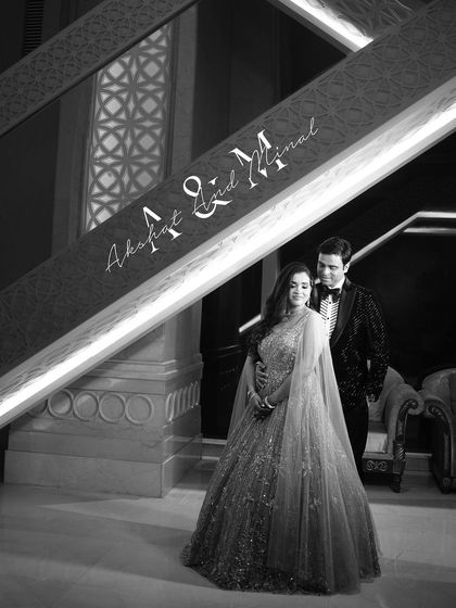 A sophisticated black and white portrait of the couple on a grand staircase. This image is a perfect example of a classic, elegant engagement announcement photo.