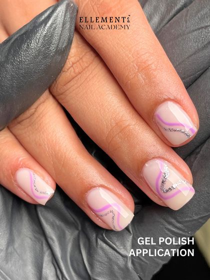 Student work showcase: A beautiful gel polish application with delicate purple and silver glitter line art, created by a student who started from scratch.