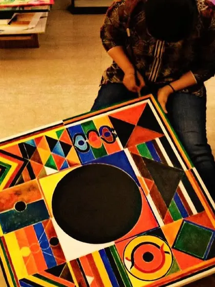 A student puts the finishing touches on a large, bold geometric canvas. My adult classes are for all skill levels, from beginners to seasoned creators.