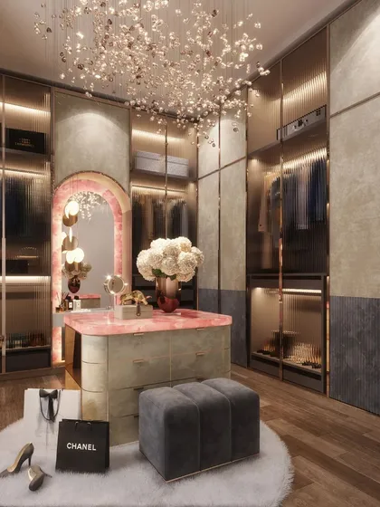 This is a dream dressing room brought to life, featuring a stunning pink onyx vanity island and custom glass wardrobes. It’s one of those little indulgences that transforms a daily routine into a luxurious experience, reflecting the client's unique style and personality.