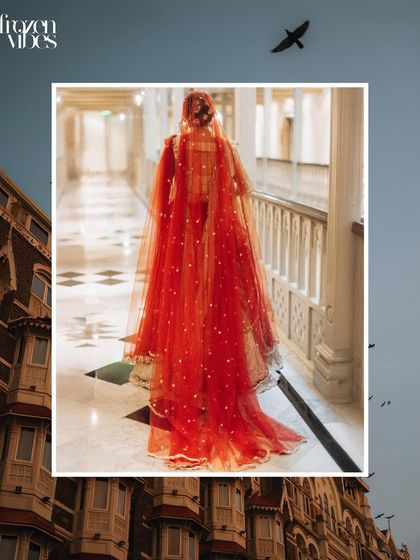 A creative shot of the bride walking down the corridor of the Taj Mahal Palace hotel, framed by the city's architecture. This tells a story of place and elegance.