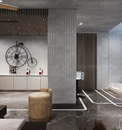 This angle shows a small bar or pantry area and a grand staircase, all part of the multi-functional entertainment space in Palam Vihar.