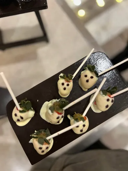 Ghostly chocolate-dipped strawberries. We used white chocolate to create these cute little ghosts, another fun addition to our Halloween catering menu.