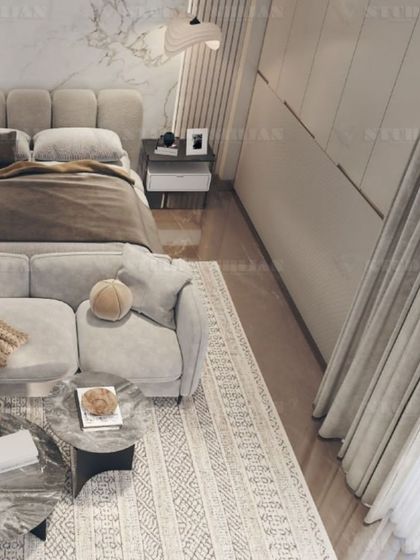 Another perspective of the plush, tufted bed and the cozy seating area, perfect for creating a private living space within the bedroom.