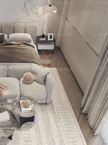 Another perspective of the plush, tufted bed and the cozy seating area, perfect for creating a private living space within the bedroom.