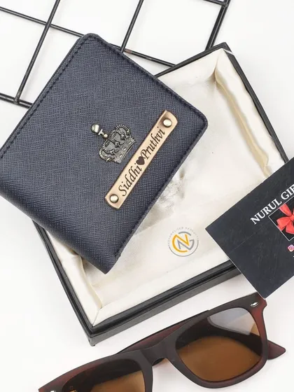 A personalized navy blue wallet with a crown charm, perfect for a couple or to include two names.