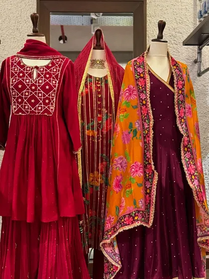 A wider view of the red and purple velvet collection, showing how different textures and prints can be combined for a rich, layered festive look.