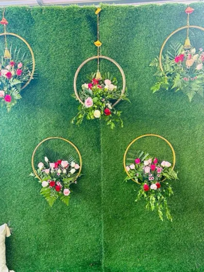 Another view of the green wall with floral hoops. This minimalist yet beautiful design is perfect for intimate Mehendi functions or as a photo booth at a larger event.