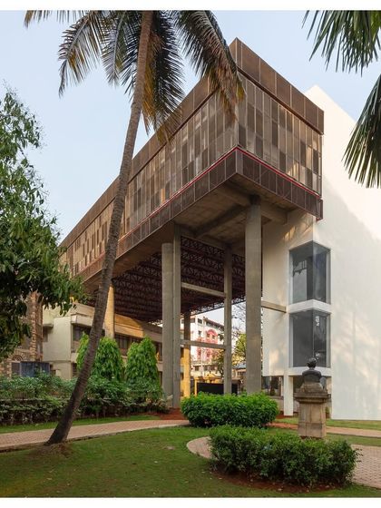 A view of "Hoverspace" from the campus gardens, showing how the new structure floats above the existing building, supported by slender concrete columns.